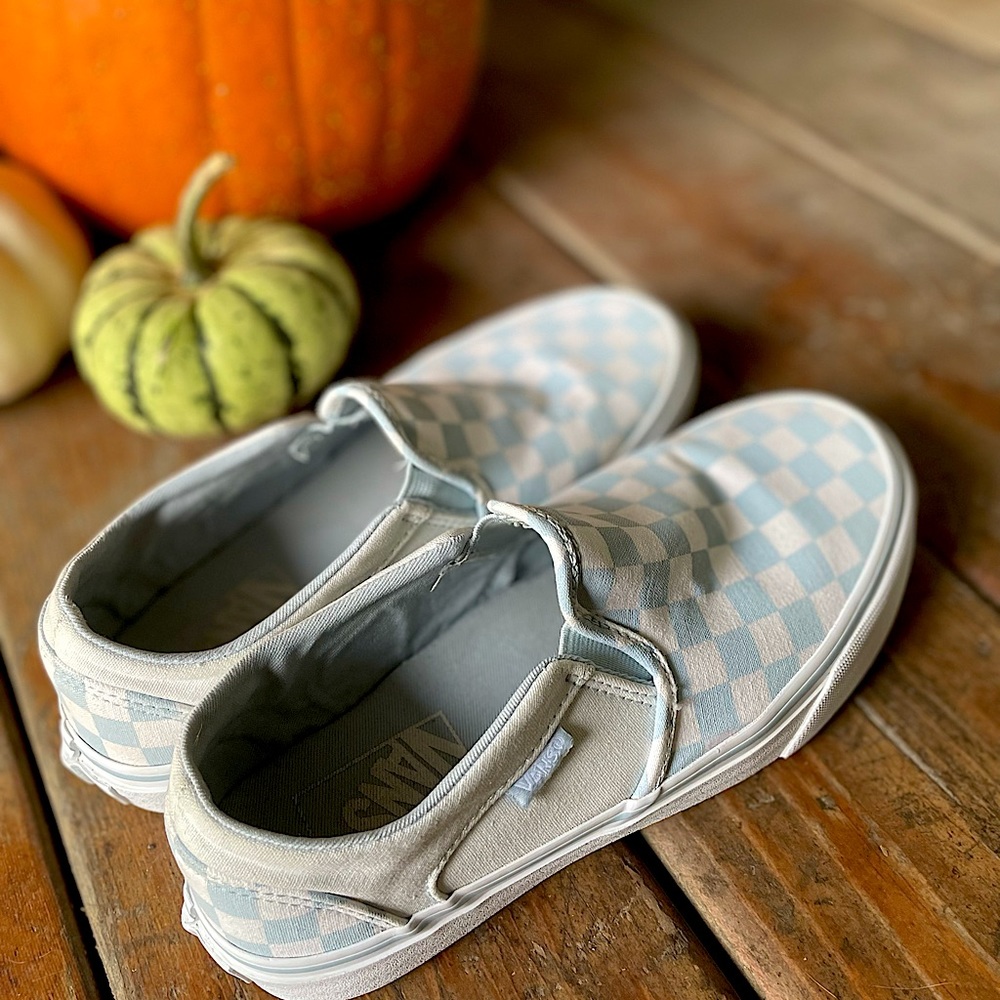 Light blue/white slip on checkered Vans.